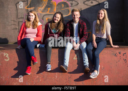 Portrait of Teenage Friends Sitting in Skateboard Park Banque D'Images