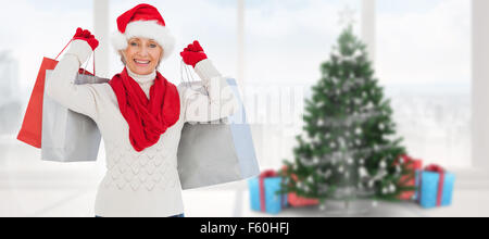 Image composite de l'ambiance festive woman holding shopping bags Banque D'Images