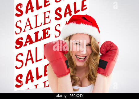 Image composite de blonde woman wearing boxing gloves smiling at camera Banque D'Images