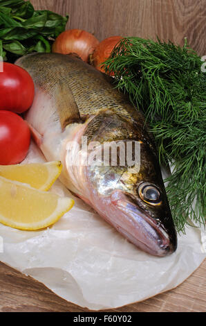 Les poissons crus sandre sur un papier près de légumes Banque D'Images