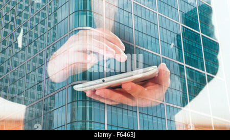 Double exposition, businessman using tablet and London office building Banque D'Images