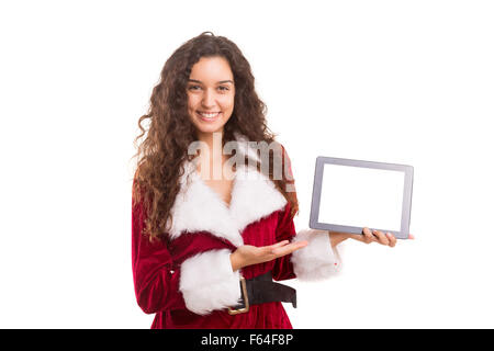 Jeune femme en robe costume Noël, la présentation de votre produit sur un ordinateur tablette Banque D'Images