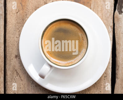 Dans un double expresso tasse blanc placé sur une table en bois en dhow. Portrait, orientation verticale. Vue élevée. Banque D'Images