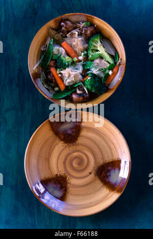 Vue de dessus de Bol en céramique et la plaque avec la soupe aux légumes, ragoût d'un bleu verdâtre du grain du bois Banque D'Images