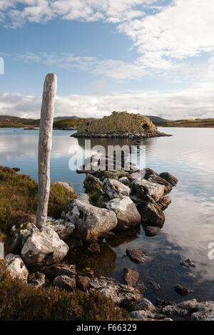 Chaussée de pierre menant à l'âge de fer galerie Baravat Dun dun ou des brochures sur une petite île dans le Loch Barabhat, Great Bernera, à l'île de Lewis. Banque D'Images