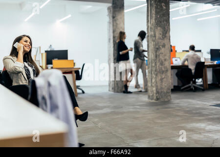 Business Woman using phone in an office Banque D'Images