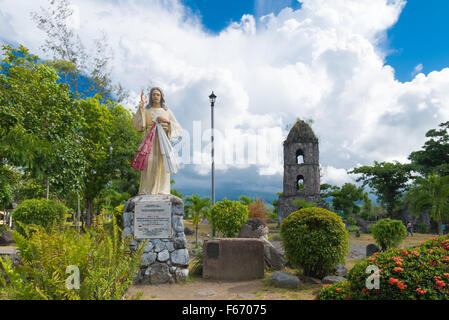 Sculpture de Jésus en face de l'Cagsawa ruines, les vestiges d'une église franciscaine du 18ème siècle, construit en 1724 et détruit par Banque D'Images