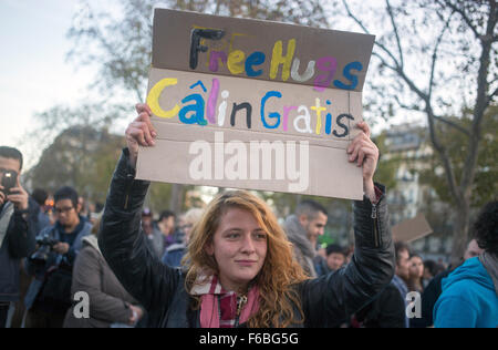 Une femme tient une pancarte "Free Hugs" à la place de la République à Paris, France le 15 novembre 2015. Au moins 129 personnes ont été tués dans plusieurs attaques terroristes à Paris le 13 novembre 2015. Photo : Simone Perolari/dpa Banque D'Images