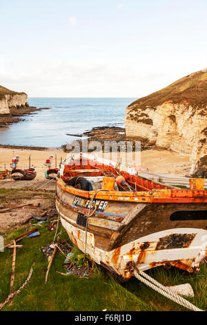 L'atterrissage à Flamborough Head North Yorkshire vieux bateau bateaux sur la terre sèche donnent sur la baie et plage côte littoral accidenté UK Angleterre Banque D'Images