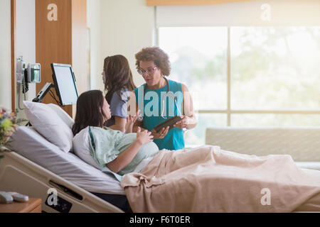 Doctor talking to patient in hospital room enceintes Banque D'Images