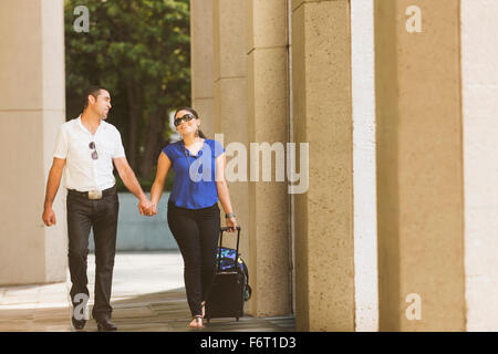 Hispanic couple holding hands sous les colonnes Banque D'Images