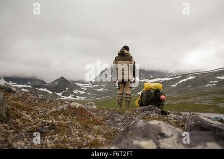 Mari backpacker standing in mountain field Banque D'Images