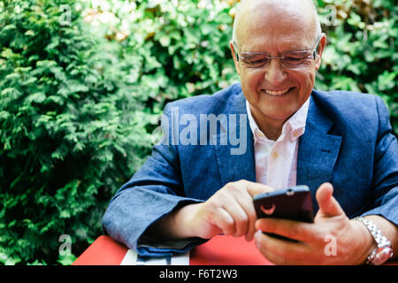 Hispanic businessman using cell phone Banque D'Images