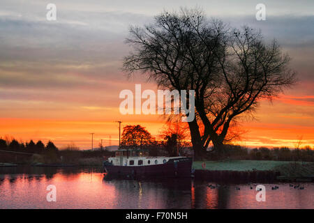 Novembre lever du soleil à Rufford, Burscough, Preston, Lancashire, UK 23 Novembre, 2015. Météo britannique. Un froid glacial, froid et démarrer la journée avec des péniches sur le canal de Leeds Liverpool se réveiller à l'aube glorieuse. La Direction générale de Rufford Rufford entre et Sollom a été construit par la navigation Douglas autour de 1760. Sept ans après la Leeds et Liverpool Canal a été achevé, une succursale de Burscough à Rufford a ouvert en 1781. La dernière section, de Sollom Tarleton à, ouvert en 1805 dans le cadre de l'amélioration du drainage Croston. Banque D'Images