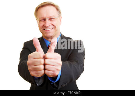 Senior businessman in a suit holding his Thumbs up Banque D'Images