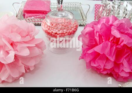 Célébration avec pompons rose, jelly beans et des bouteilles avec des pailles gris Banque D'Images