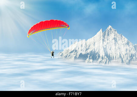 Parapente Freestyle solo à haute altitude dans le ciel au-dessus de nuages contre sommet de montagne Banque D'Images