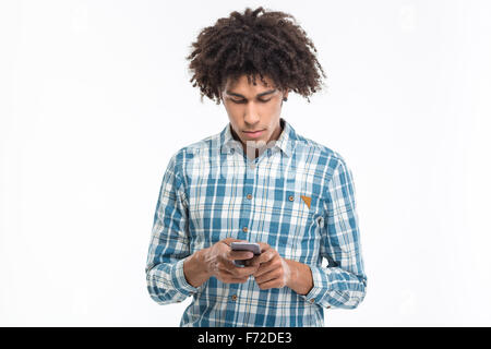 Portrait d'un jeune afro-américain man using smartphone isolé sur fond blanc Banque D'Images