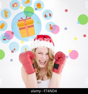 Image composite de blonde woman wearing boxing gloves smiling at camera Banque D'Images