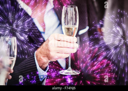 Composite image of a senior man holding a glass of champagne Banque D'Images