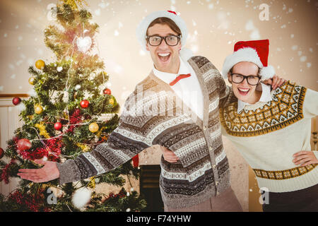 Image composite de portrait of smiling woman with hand on hip avec l'homme Banque D'Images