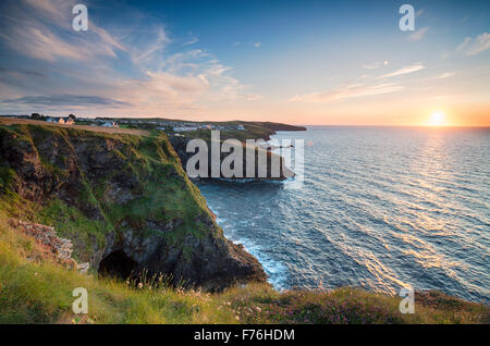 Magnifique coucher de soleil sur la côte de Cornouailles de Port Gaverne et à la recherche en direction de Port Isaac dans la distance Banque D'Images