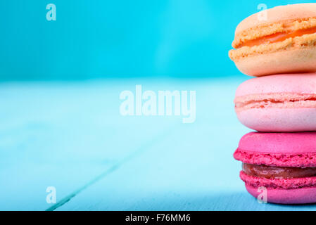 Macarons Français colorés sur fond bleu Banque D'Images