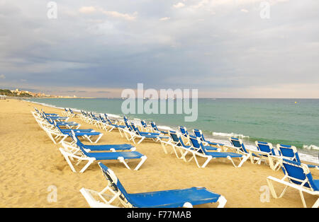 Chaises longues sur une plage de galets, face à la mer Banque D'Images