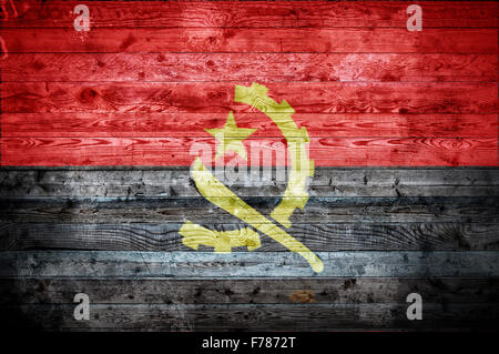 Une vignetted image de fond du drapeau de l'Angola peints sur des planches de bois d'un mur ou le plancher. Banque D'Images