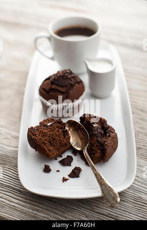 Muffins au chocolat avec du café sur table en bois Banque D'Images