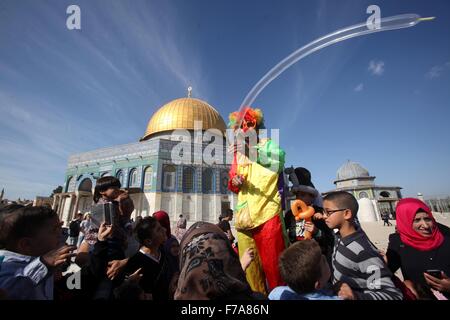 Jérusalem, Jérusalem, territoire palestinien. 27 Nov, 2015. Un clown joue avec les enfants palestiniens en face de la coupole de la mosquée de Rock après la prière du vendredi à la mosquée al-Aqsa, troisième lieu saint de l'Islam, dans la vieille ville de Jérusalem le 27 novembre 2015 Crédit : Mahfouz Abu Turk/APA/Images/fil ZUMA Alamy Live News Banque D'Images