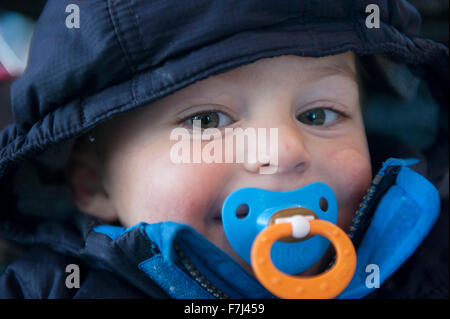 Bébé garçon avec sucette dans sa bouche, portrait Banque D'Images