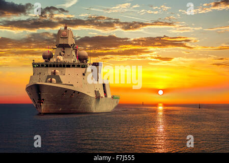 Le navire militaire sur la mer au lever du soleil. Banque D'Images