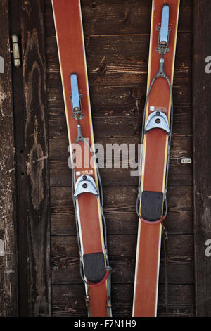 Vintage paire de ski en bois contre le mur d'une cabane de ski Banque D'Images