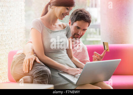 Couple shopping en ligne de l'ordinateur d'accueil Banque D'Images