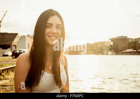 Allemagne, Munster, portrait of smiling young woman in front of city Harbour Banque D'Images