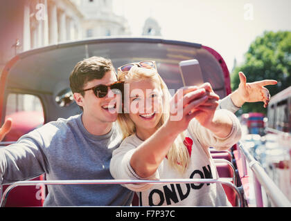 Couple sur selfies bus à impériale à Londres Banque D'Images