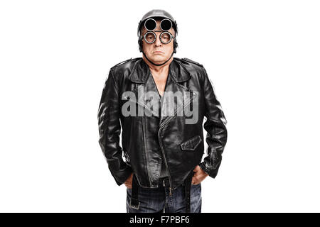 Grumpy young motocycliste posant dans un blouson de cuir noir avec un casque et lunettes isolé sur fond blanc Banque D'Images