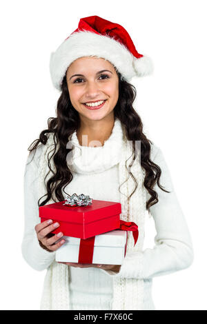 Smiling woman with christmas hat holding gifts Banque D'Images