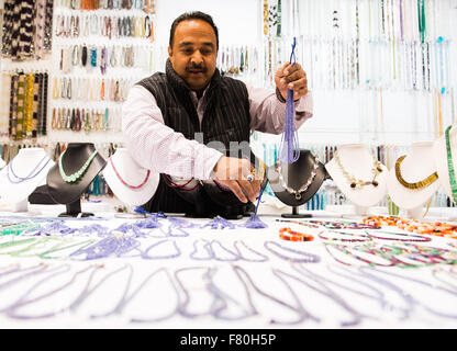 Hambourg, Allemagne. 19Th Mar, 2015. Un négociant necklacess gem organise à son stand lors de la foire commerciale des minéraux de Hambourg à Hambourg, Allemagne, 3 décembre 2015. La foire se poursuit jusqu'au 6 décembre 2015. Photo : Daniel Bockwoldt/dpa/Alamy Live News Banque D'Images