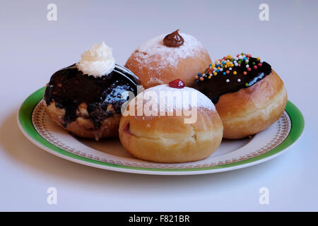 Traditionnel avec élégance Sufganiyot rond donut frites consommées pendant la fête juive de Hanoukka, la fête des lumières Banque D'Images