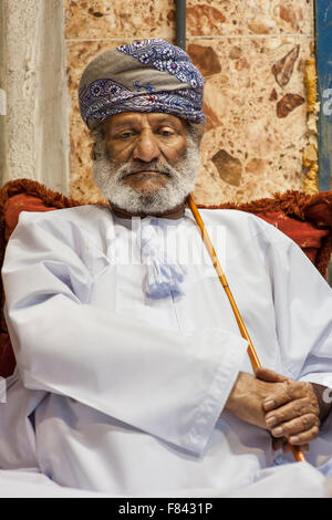 Homme assis à l'extérieur de son omanais stocker dans le souk de Mutrah à Muscat, capitale du Sultanat d'Oman. Banque D'Images