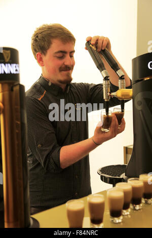 Un bartender pouring beer Guinness dans testing verres de Guinness Storehouse, Dublin Irlande Banque D'Images