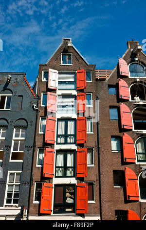 Immeubles d'appartements, maisons hollandaises résidentielles traditionnelles avec volets rouges ouverts à côté du canal, centre d'Amsterdam, Hollande, pays-Bas, Europe, UE Banque D'Images