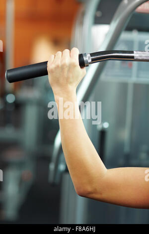 Femme faisant des exercices sur une machine dans une salle de sport lat Banque D'Images