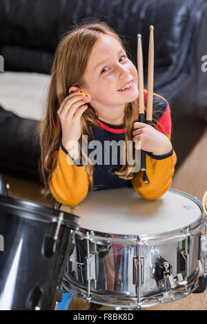 Petite fille de 9 ans à jouer de la batterie. Banque D'Images
