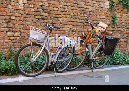 Deux vélos près de mur de brique dans le centre de Rimini, Italie Banque D'Images