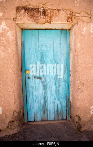 Ancien en bois pâle porte coloniale et l'architecture d'adobe dans un petit village de Potosi. La Bolivie Banque D'Images