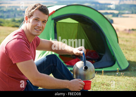 Jeune homme Camping à la campagne Banque D'Images