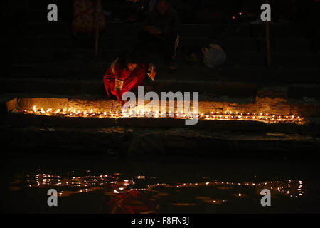 Katmandou, Népal. 9Th Mar, 2015. Un dévot hindou lights lampes à huile au cours de Bala Chaturdashi festival au temple de Pashupatinath. Festival Bala Chaturdashi a lieu en mémoire des morts bien-aimés. Il est estimé par l'exécution de rituels Chaturdashi Bala un meilleur endroit dans le ciel peut être sécurisé pour mort des parents. © Skanda Gautam/ZUMA/Alamy Fil Live News Banque D'Images